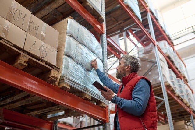 Manager in Workwear Checking Bar Codes Medium